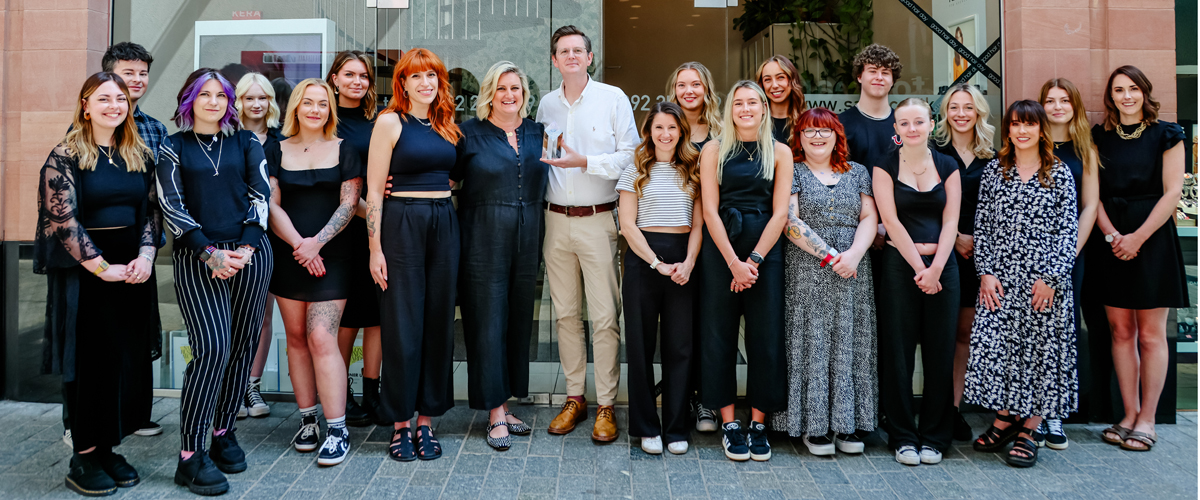 Saks Hair Exeter team standing in front of the salon posing for a team picture.