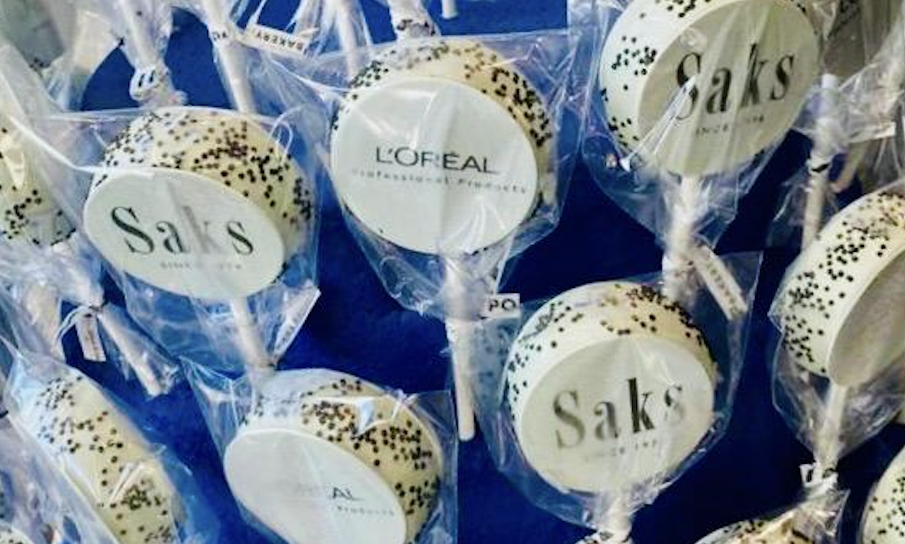 Cute lollypops with Saks and L'Oreal Professionnel logos on